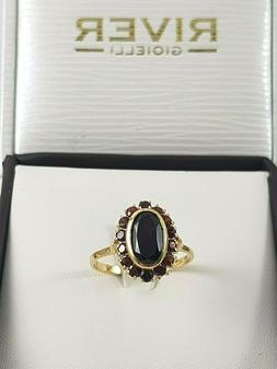Anello da donna in oro giallo 18 kt con pietre granato rosso